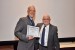 Dr. Nagib Callaos, General Chair, giving Dr. Russell Jay Hendel the best paper award certificate of the session "Educational Research, Theories, Practice and Methodologies." The title of the awarded paper is "Several Interdisciplinary Applications to UDL."